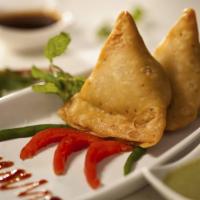 Samosa · Crispy fried pastry filled with potatoes and green peas flavored with fresh spices.