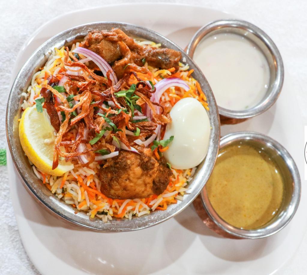 Hyderabadi Chicken Dum Biryani · Flavored with exotic spices and cooked with basmati rice. Served with raitha and gravy.