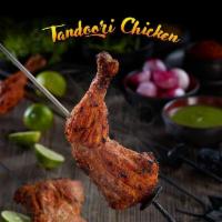 Tandoori Chicken (Full) · Grilled bone-in chicken marinated in yogurt, garlic, ginger, and fresh ground spices.