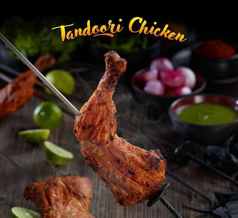 Tandoori Chicken (Half) · Grilled bone-in chicken marinated in yogurt, garlic, ginger & fresh ground spices.