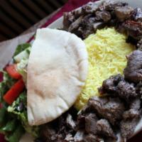Beef Shawarma · Thin slices of meat stacked on a stand up grill that revolves.