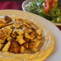 Hummus Shawarma Plate · Beef or chicken shawarma served over hummus with a side garden salad and pita bread.