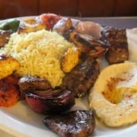 Kabobs and Grilled Veggies Feast · Grilled beef, chicken, lamb, and kafta kabobs, served with rice, hummus, grilled onion and t...