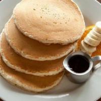 Buttermilk Pancakes · Buttermilk pancakes are served with pancake syrup and butter on the side. For an extra treat...
