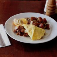 Country Omelet · Organic eggs, smoky apple wood bacon, potatoes and cheddar cheese. Served with roasted red p...