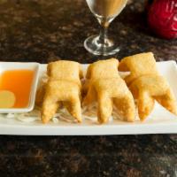 Cheese Wontons · 6 pieces. Creamy cream cheese mixed with relish and wrapped in crispy fried wonton skin.