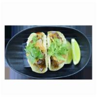 Pork Chashu and Kimchee Tacos · Slow braised pork chashu and kimchi in a crispy wonton taco shell.