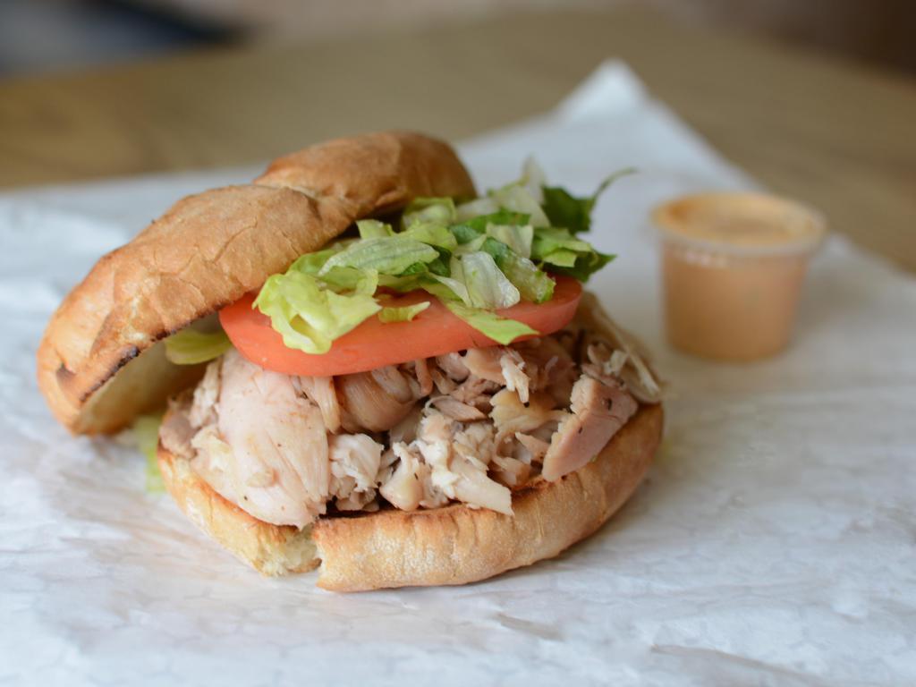 Chicken (Leg) (#1) · Chunks of dark meat with iceberg lettuce and tomato in a toasted roll or as a wrap.