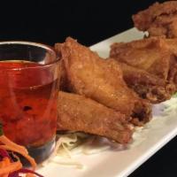 A3. Chicken Wings · 5 pieces. Marinated in herbs and spices. Served with sweet chili sauce.
