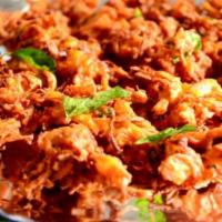 Onion Pakoda · Sliced onions and green chilies mixed with chickpeas flour and fried until golden brown.