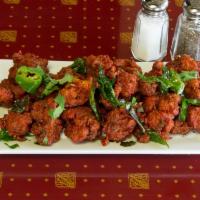 Gobi Manchurian · Fried cauliflower fritters tossed with soya sauce based gravy cooked to the chef's perfection.
