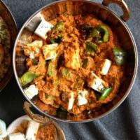 Paneer Butter Masala · Vegetarian delight cottage cheese cooked in cream and tomato gravy.
