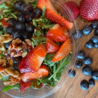 The Berry Salad · Organic Baby Arugula, Fresh Strawberries, Blueberries, walnuts and Raspberry Vinaigrette.