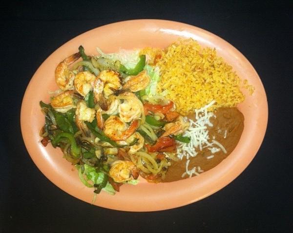 Camarones Rancheros · Shrimp with bell peppers, onions, tomatoes and mild sauce with rice, beans, lettuce and tortillas.