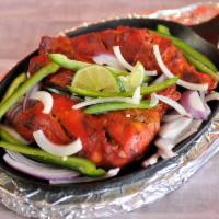 Chicken Tandoori · Spring chicken marinated in yogurt, freshly ground aromatic herbs and spices. Cooked in a cl...