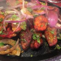 Tandoori Mixed Grill · A combination of chicken tandoori, fish tandoori, chicken tikka, lamb tikka, sheekh kebab, a...