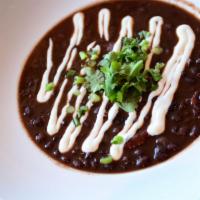 Chipotle Black Bean Soup · Lime crema, scallions and cilantro. Spicy, vegetarian and gluten-friendly.