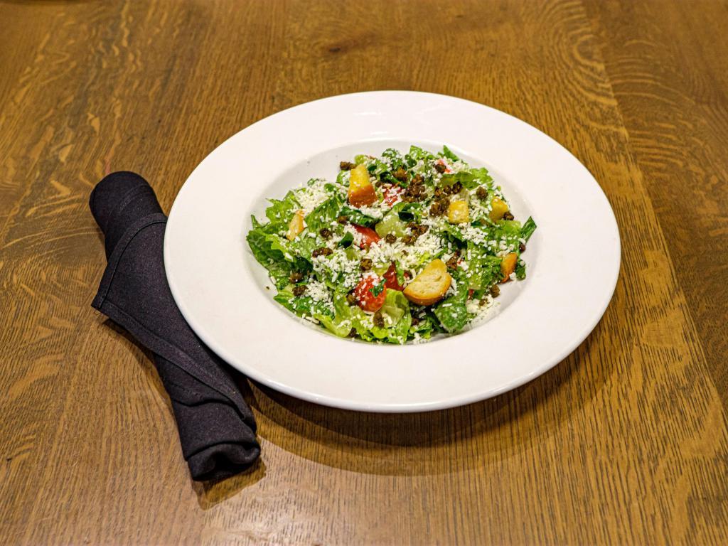 Caesar Salad · Romaine heart, queso fresco, crispy capers, tomatoes, croutons and sugar cane dressing.