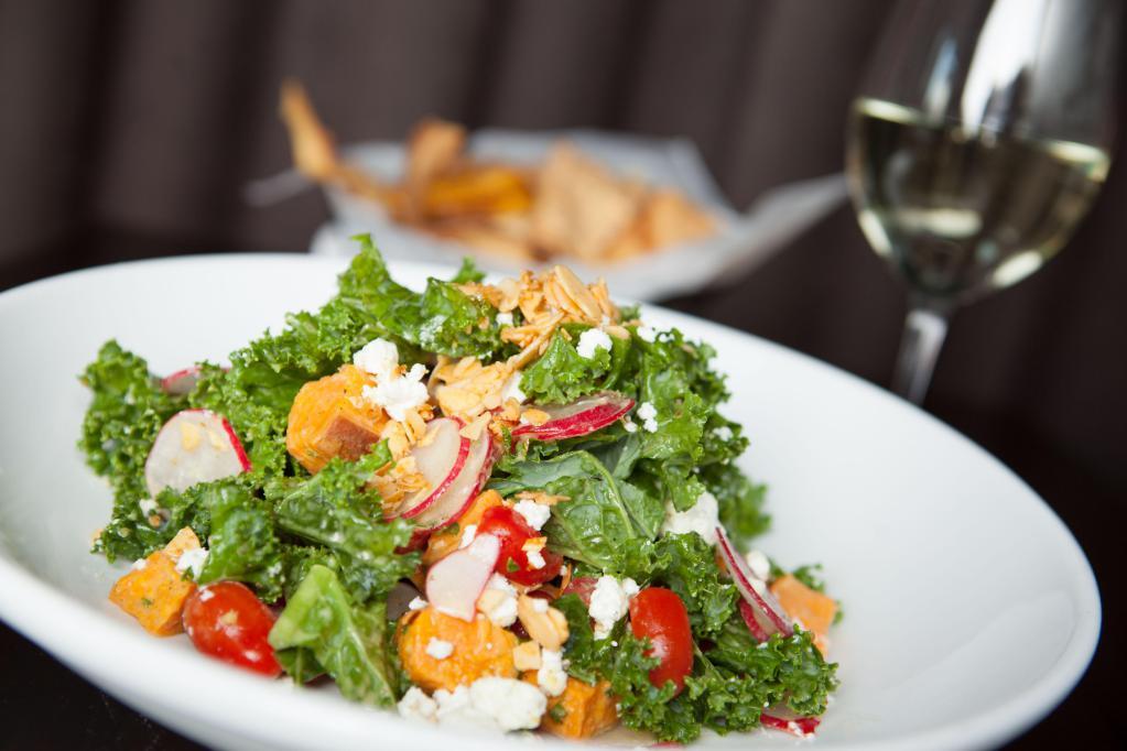 Kale and Roasted Sweet Potato · Spinach, tomatoes, spiced almonds, radish, goat cheese and garlic thyme vinaigrette. Vegetarian and gluten-friendly.