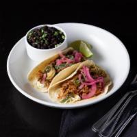 Pork Pernil Taco · Adobo rub, pickled jalapenos, pickled red onions and hot sauce. Two tacos per order; served ...