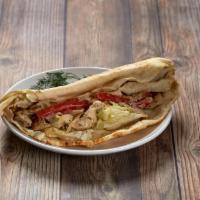 Chicken Shawarma Sandwich · Wrapped in pita bread and served with lettuce, tomatoes, grilled onions and tahini (ground s...