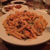 Penne Alla Calabrese · Penne with chicken breast sauteed with peas and mushrooms in pink sauce.