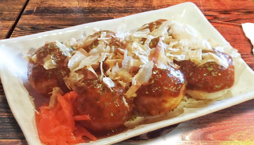 Takoyaki · 6 pieces of flour balls with diced octopus inside served with bonito flakes, mayo and sauce