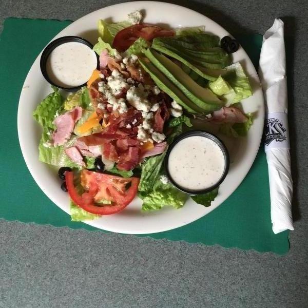 Cobb Salad · Served with tomatoes, bacon, egg, ham, cheese, blue cheese crumbles, olives and blue cheese dressing.