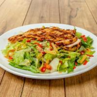 Grilled Chicken Mexican Caesar Salad · Romaine lettuce, cotija cheese, tomatoes, roasted pepitas and crisp tortilla strips tossed i...