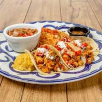 Street Taco Trio · Three chicken or carnitas street tacos served with frijoles de la olla and rice.