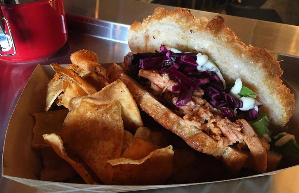 Turkey 'Mondulo' · House-smoked pulled turkey breast marinated in chipotle and Negra Modelo, with honey-cilantro red cabbage slaw and rosemary garlic aioli on grilled sourdough. Served with house seasoned chips.