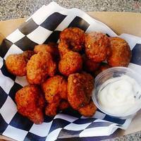 Curry-Ous Cauli Bites · Breaded & deep fried cauliflower bites tossed in a curried garlic butter sauce, topped with ...