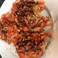 Bruschetta · Toasted garlic bread topped with diced tomatoes, basil and garlic.