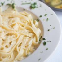 Fettuccine Alfredo Dinner · Egg noodles in a cheese and cream sauce.