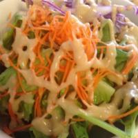 Green Salad · Mixed greens and romaine heart with creamy sesame dressing.