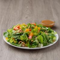 Grilled Chicken Salad · Crisp romaine lettuce with grilled chicken, Mandarin oranges, sliced almonds, tomatoes, cucu...