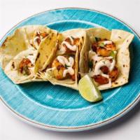 Grilled Shrimp Tacos · Three grilled shrimp tacos in flour tortillas filled with raw cabbage, cilantro, and our hom...