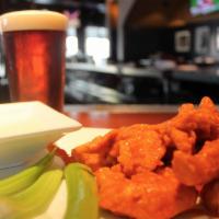 Boneless Buffalo Tenders · Chicken tenders tossed in Buffalo sauce, served with celery sticks and bleu cheese dressing ...