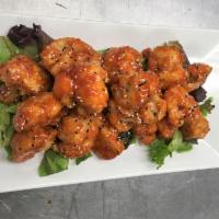 Fried Cauliflower · Crispy cauliflower tossed in honey Sriracha sauce topped with sesame seeds and served with r...
