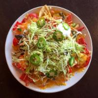 Nachos · Corn tortilla chips, cheddar and Jack cheese, shredded lettuce, chopped onion, diced tomato ...