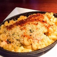 Mac and Cheese · Cavatappi pasta, folded in a creamy cheese sauce, topped with Parmesan bread crumbs and baked.