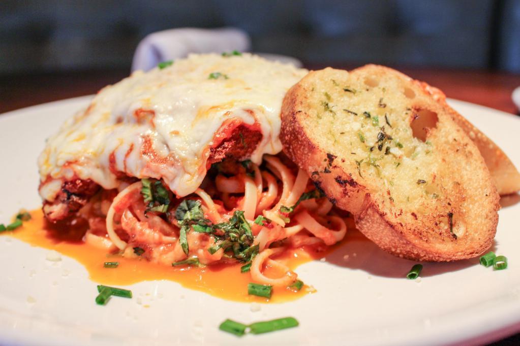 Chicken Parmigiana · Thin chicken breast, lightly fried, topped with marinara sauce and mozzarella cheese, served over linguine.