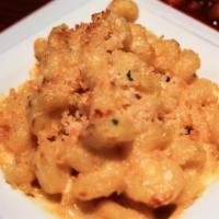 Mac and Cheese · Cavatappi pasta, folded in a creamy cheese sauce, topped with Parmesan bread crumbs and baked.
