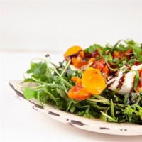 Burrata Caprese Salad · Organic baby arugula, oven roasted grape tomato, fresh basil, olive oil and balsamic glaze.