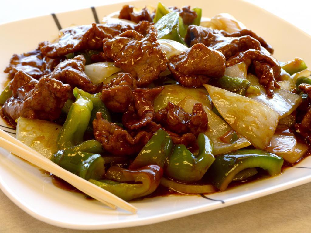 63. Pepper Steak with Onions · Served with rice.