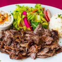 Lamb Shawarma Plate · Slow roasted thinly sliced lamb. All plates served with rice, salad, hummus and pita bread.