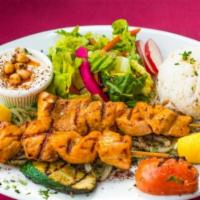 Seafood Kebab Plate · Grilled salmon and prawns.  served with rice, salad, hummus and pita bread.