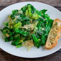 Caesar Salad · Chopped romaine lettuce tossed with caesar dressing, croutons and parmesan cheese.