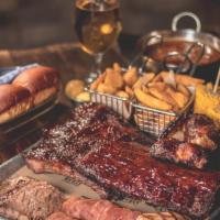 Personal BBQ Tray · Baby back ribs, pull pork, chicken breast, brisket, sausage, fries, corn on the cob and a di...
