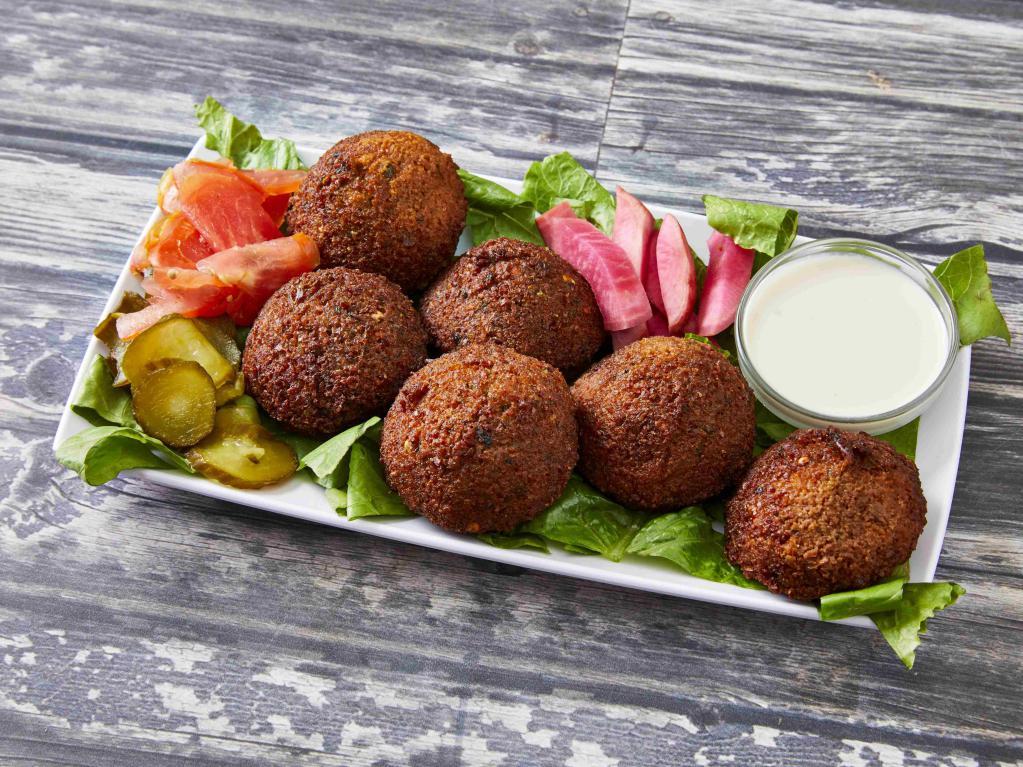 Falafel Plate · Vegan. 6 pieces. All vegetable patties made of fava beans, chickpeas, onions, parsley, cilantro and special spices, cooked in vegetable oil. Served with tahini sauce, tomatoes and pickles.